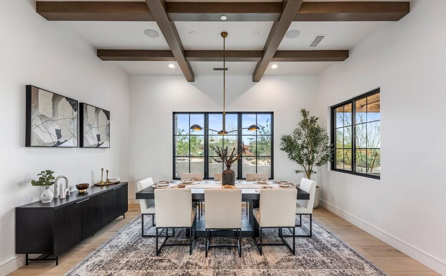 Dining room with beamed ceiling and steel framed windows