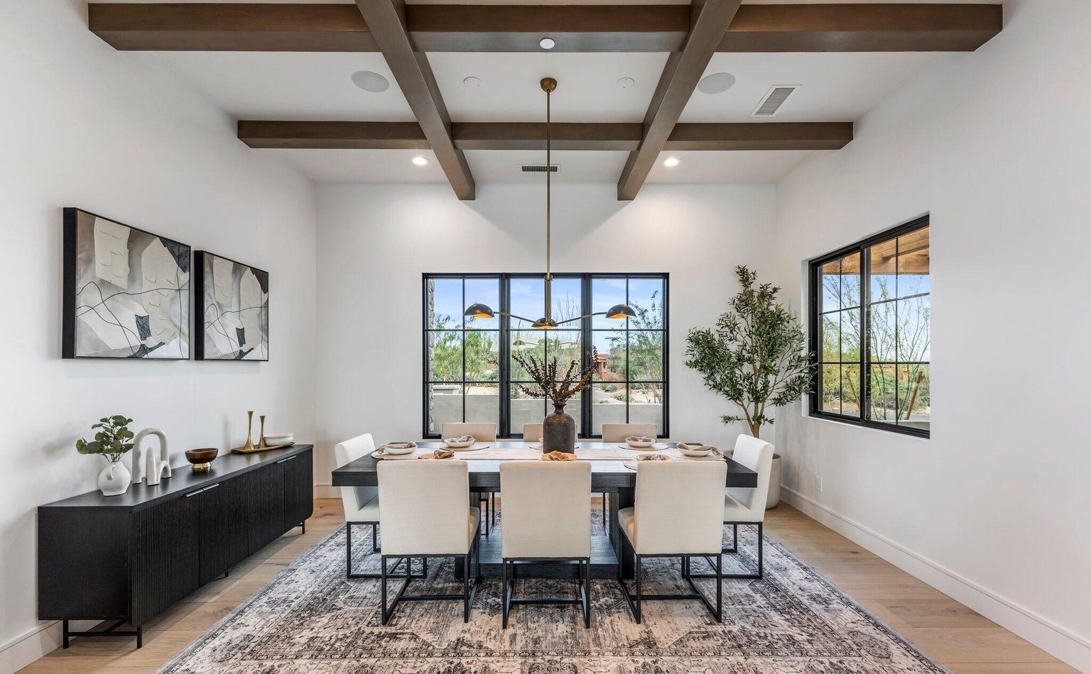 Dining room with beamed ceiling and steel framed windows