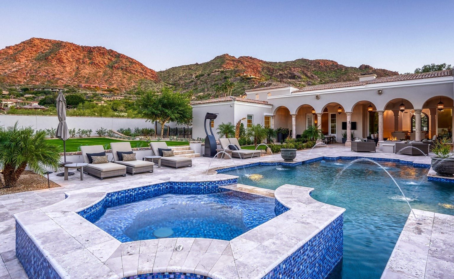 Resort pool and spa with mountain backdrop at an Arizona luxury residence